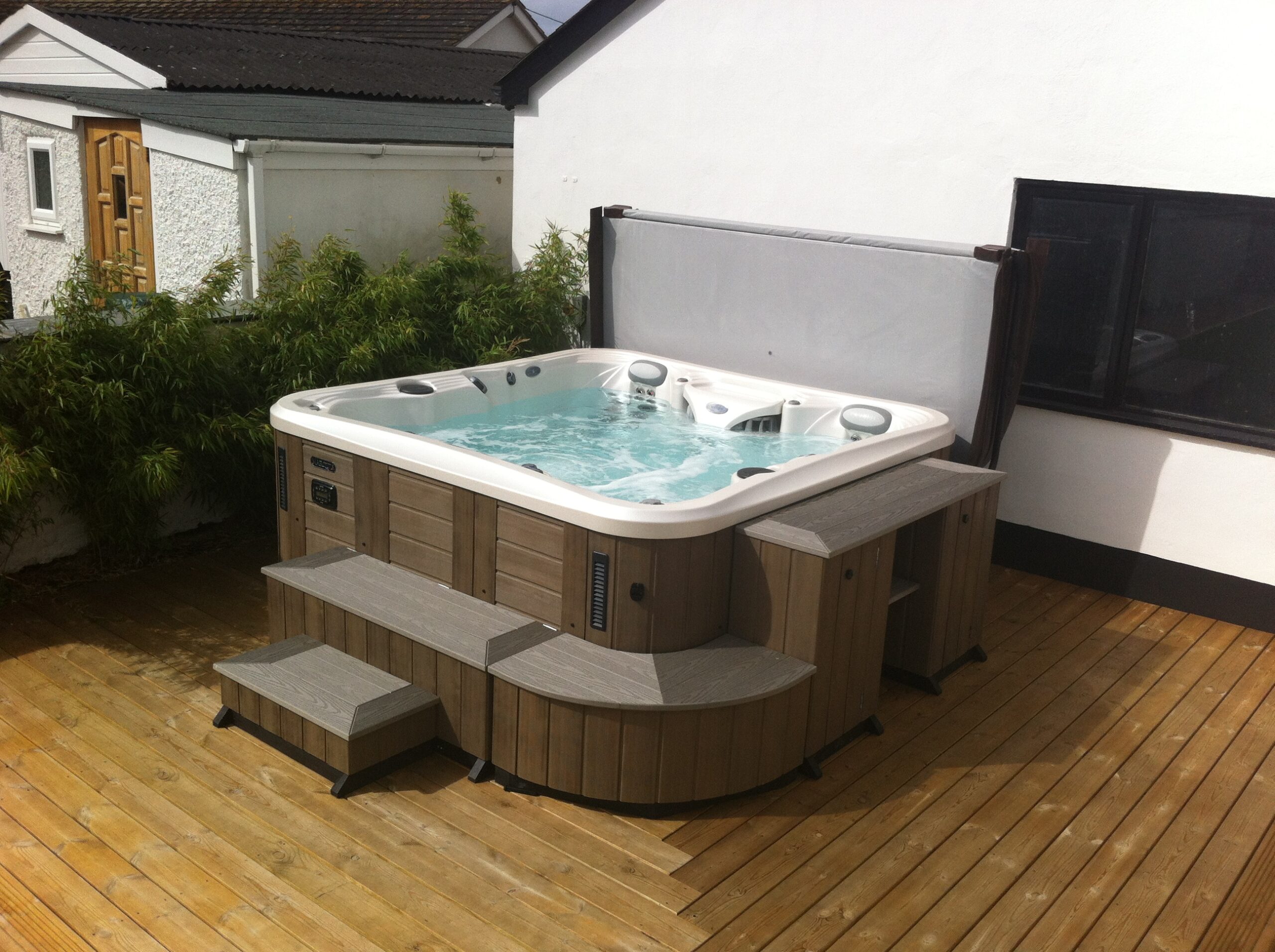 Marquis Spas Crown Epic Hot Tub on decking with surrounding bench