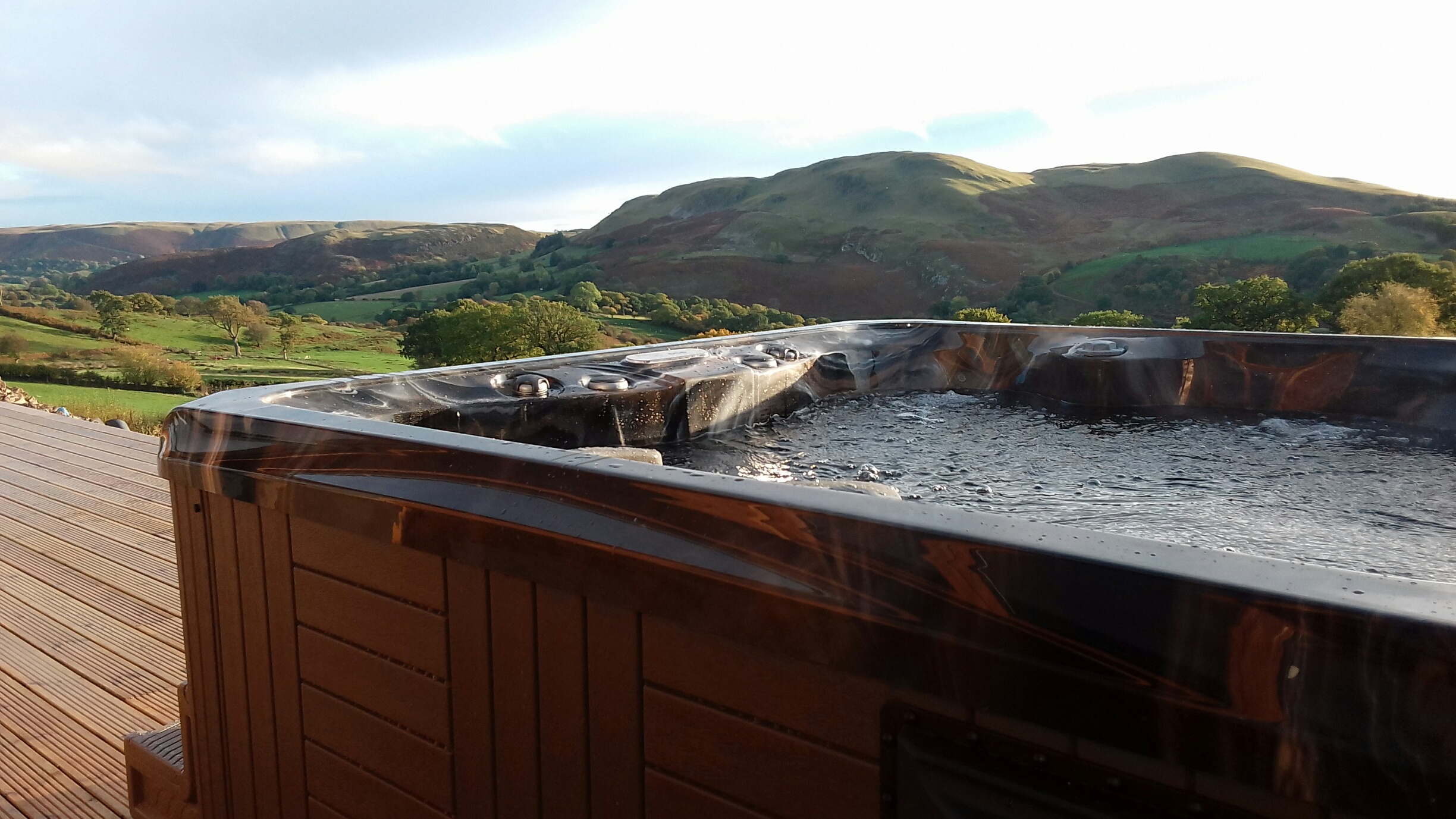 Marquis Spas Celebrity Broadway Hot Tub on a decking with cover open