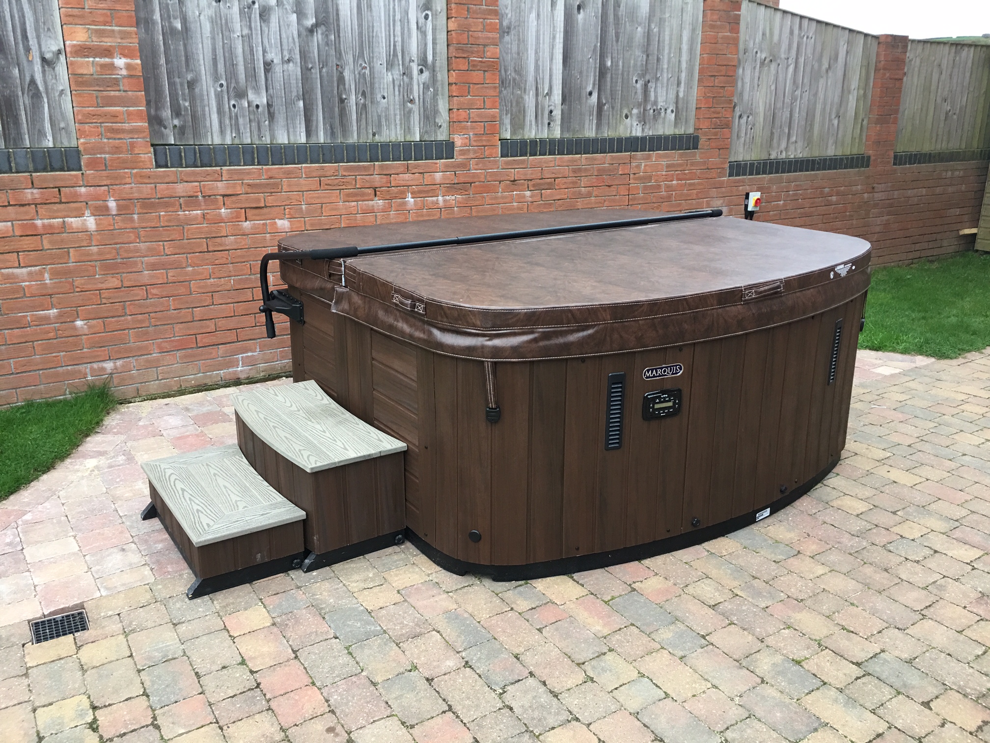 Marquis Spas Crown Resort Hot Tub with closed cover on patio
