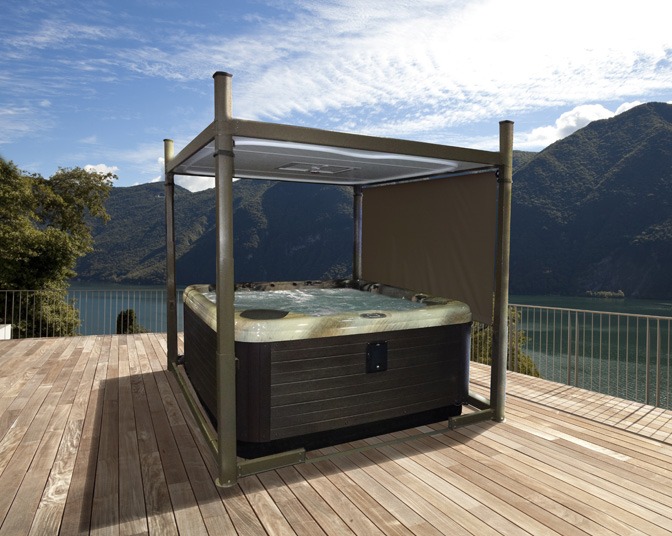 An outdoor lifestyle image of a hot tub on a decking, fitted with an open Covana Evolution automated gazebo cover