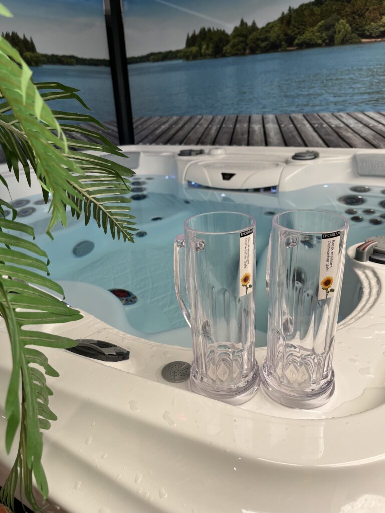 Two spa glasses on the edge of a hot tub