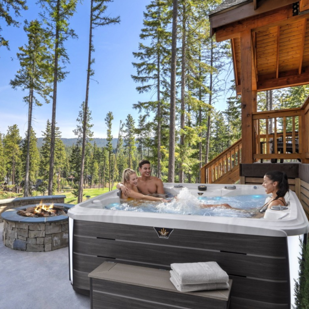 A lifestyle image of an alpine landscape with a man and woman enjoying the Marquis Crown Summit hot tub